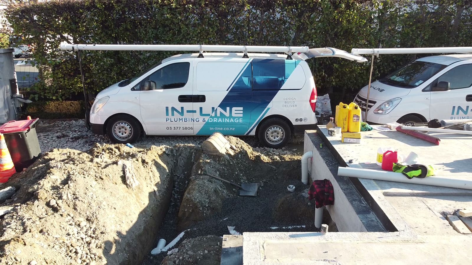 Branded Inline Plumbing and Drainage van on a Christchurch job beside an open drainage trench